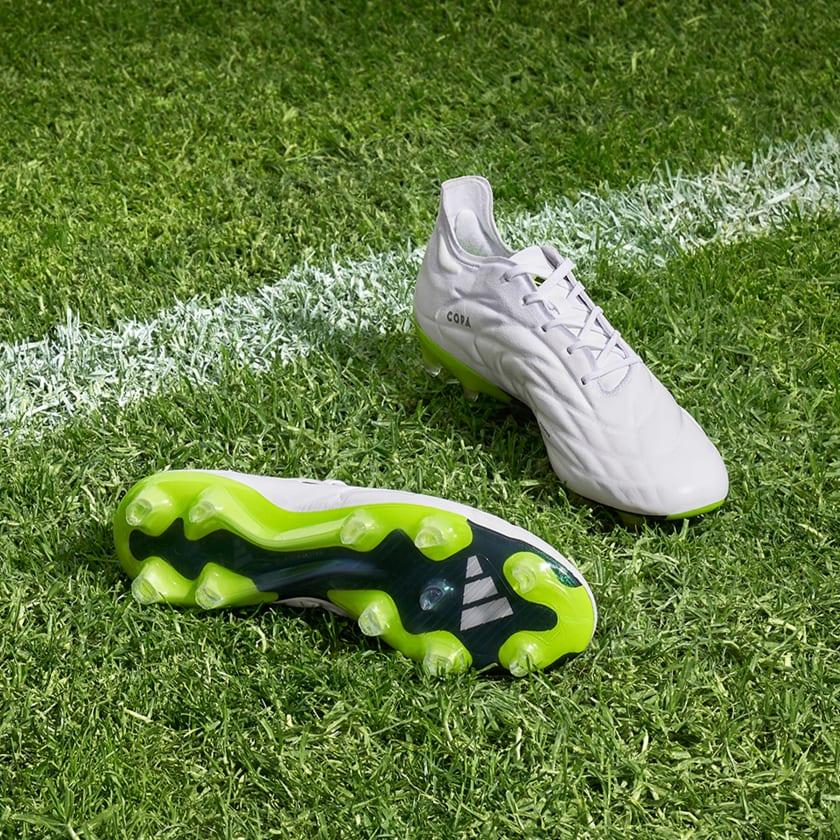 Modern football boots showing specialized studs and performance construction